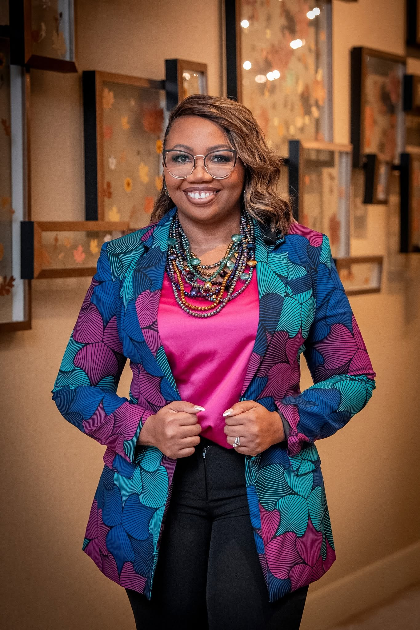 Shayla N. Atkins smiling in a patterned blazer